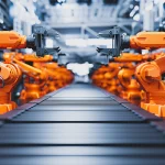 Robotic arms along assembly line in modern factory.